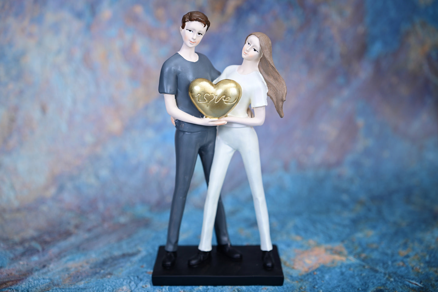 Together in Love – Couple Holding Golden Heart Figurine