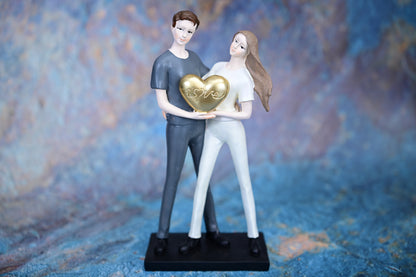 Together in Love – Couple Holding Golden Heart Figurine